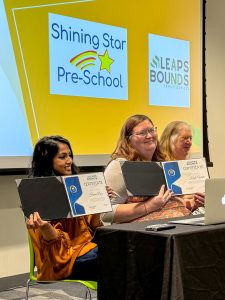 Kayla receiving her apprenticeship completion certificate at the Race to Talent event.